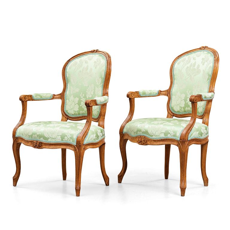 Two matched Louis XV 18th century armchairs.