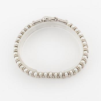 An 18K white gold bracelet set with cultured pearls and round brilliant-cut diamonds.