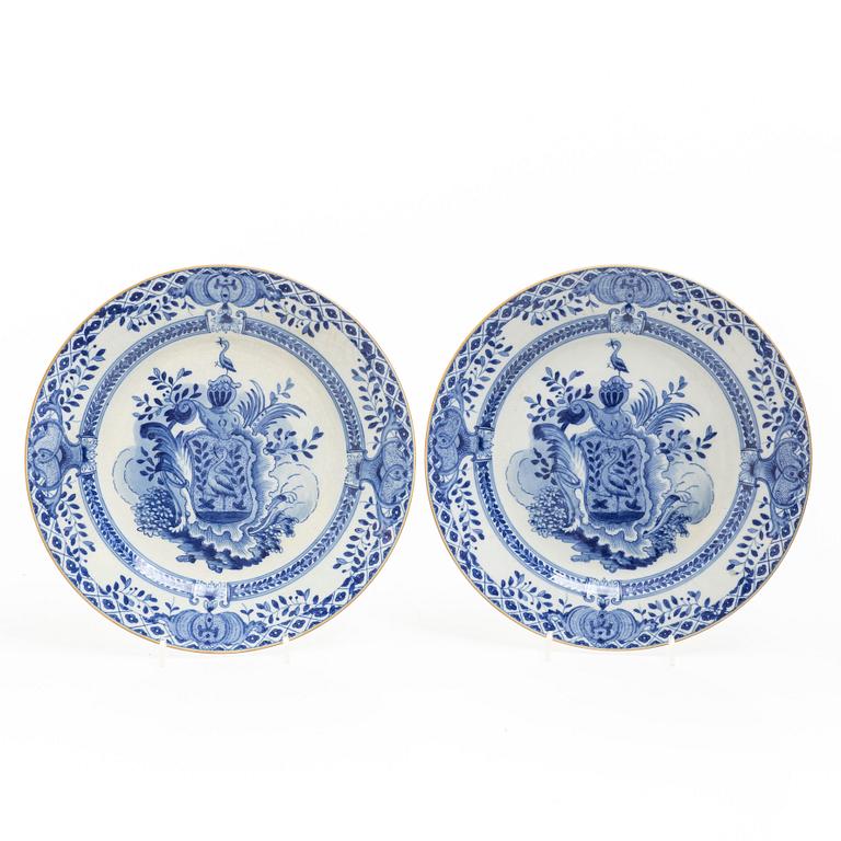 A pair of armorial dinner plates, soft paste, Qing dynasty, 18th century.