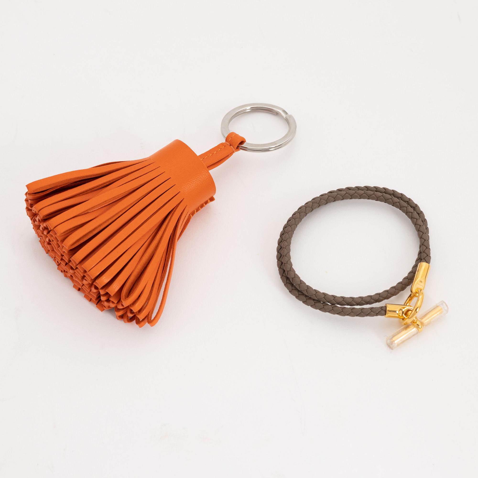 Hermès, a leather bracelet and key chain.