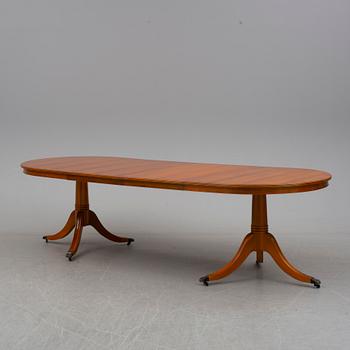 a late 20th century dining table with eight chairs.