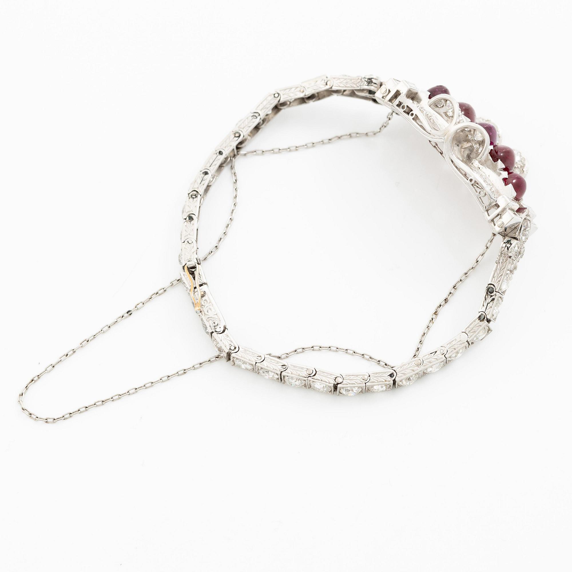 A bracelet platinum set with old- and baguette-cut diamonds and cabochon-cut rubies, circa 1930-40s.