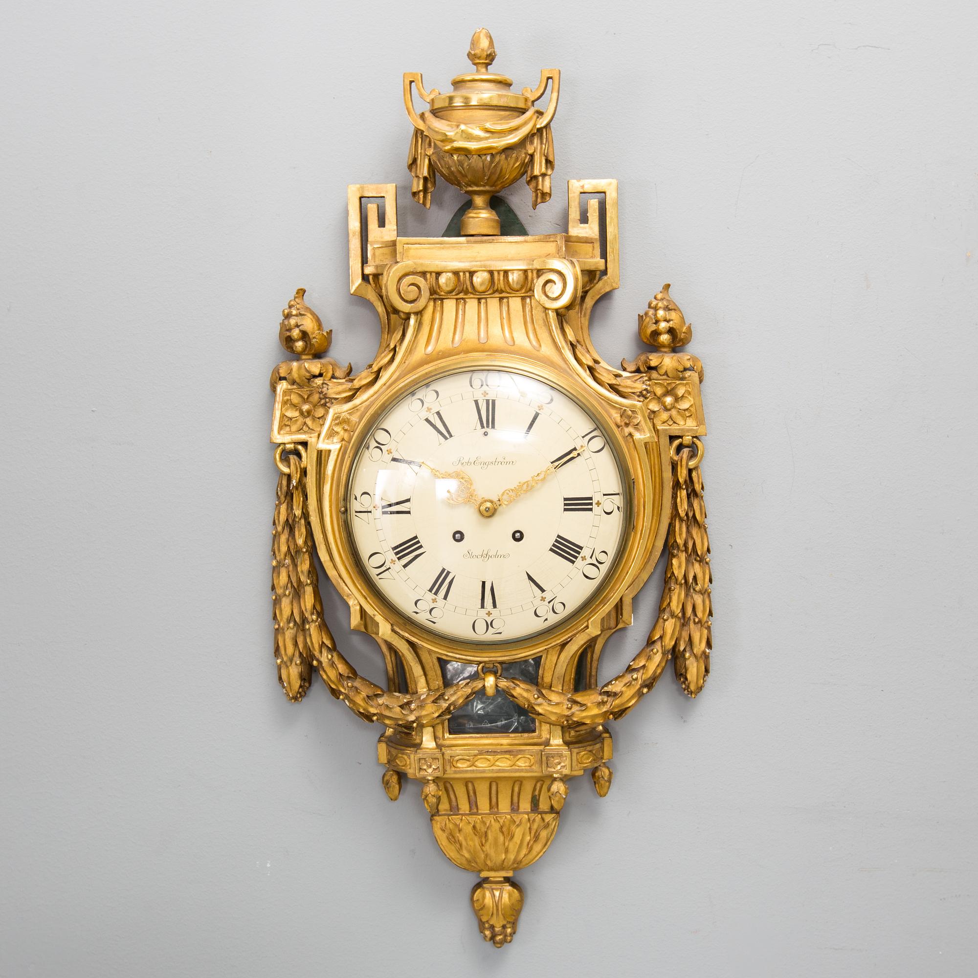 A wall clock in gustavian style, marked Rob. Engström, Stockholm.