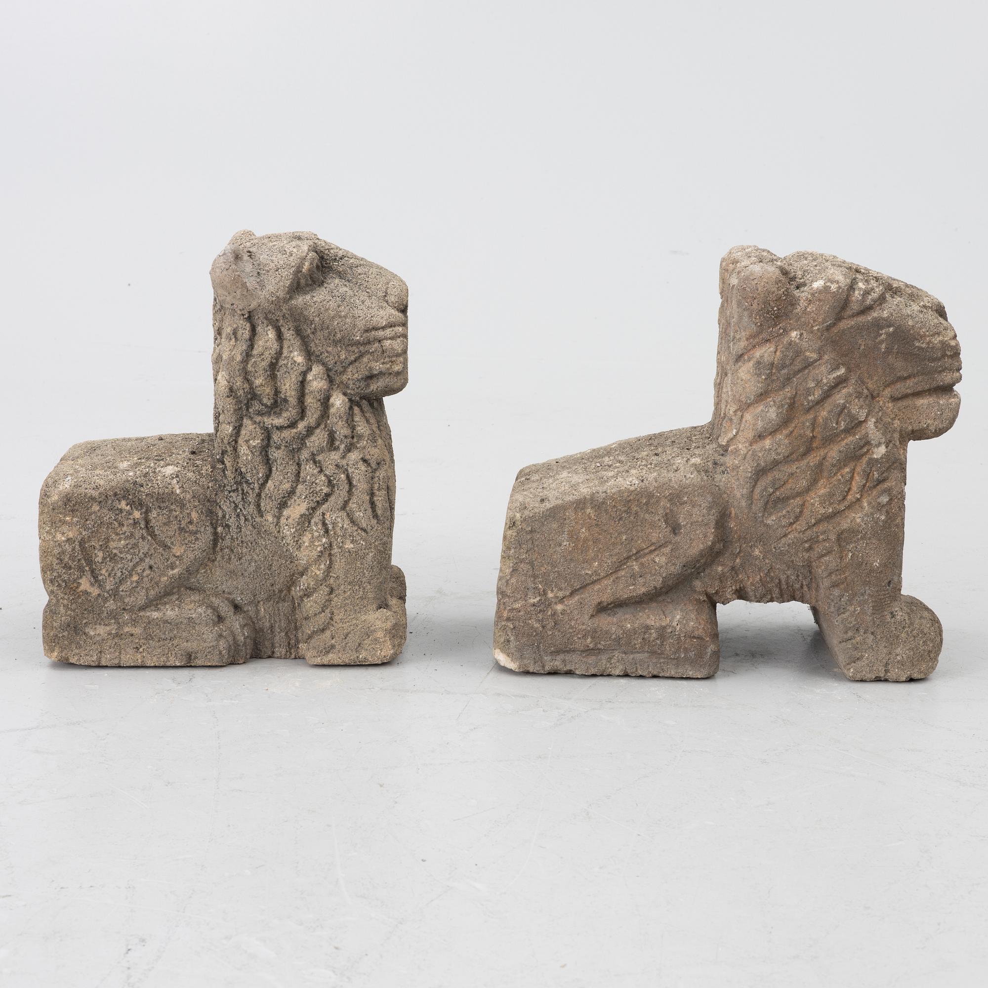 A set of two lion garden sculptures.
