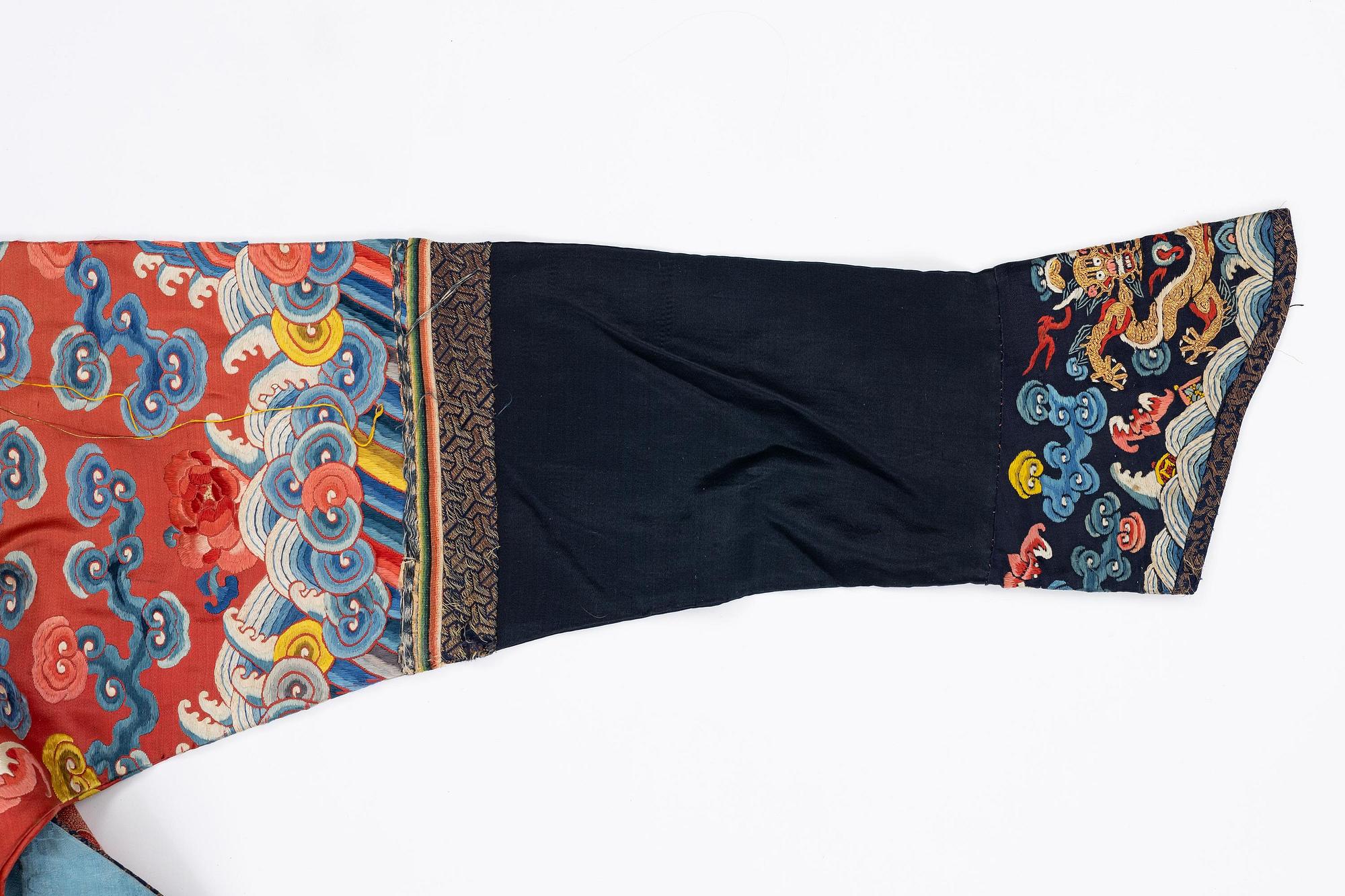 An embroidered red ground five clawed dragon 'female' formal robe, Qing dynasty, 19th century.