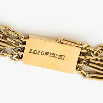 A W.A. Bolin necklace in 18K gold with pearls and white discs.