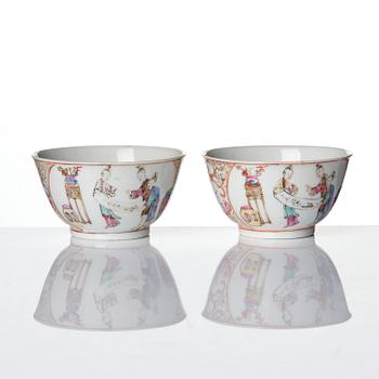 A pair of famille rose 'figural' tea cups with saucers, Qing dynasty, Qianlong (1736-95).