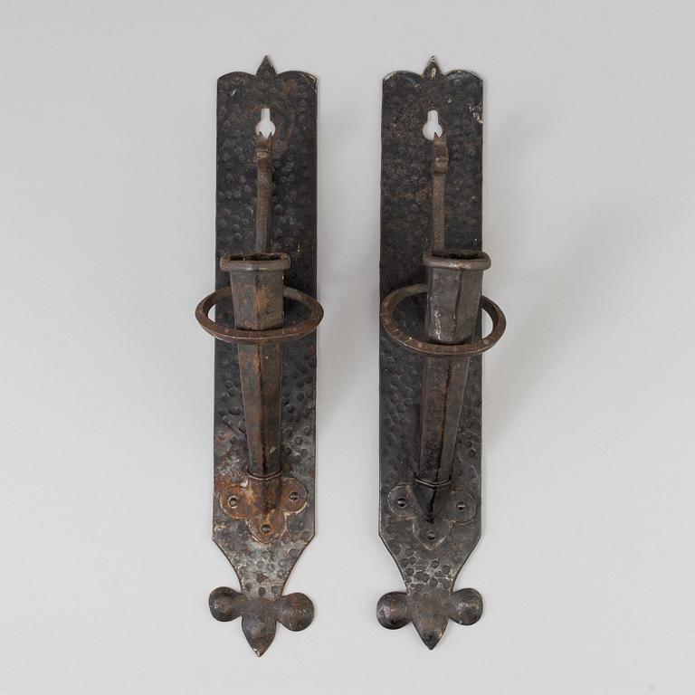 A pair of 20th century wrought iron torch holders.