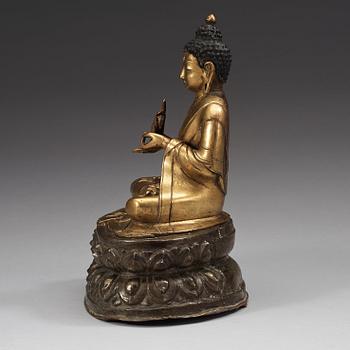 A gilt and silvered copper alloy repoussé figure of Sakyamuni Buddha, Tibet/Nepal, 18th Century.