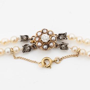 Pearl necklace with a gold clasp set with an old-cut and rose-cut diamonds and pearls.