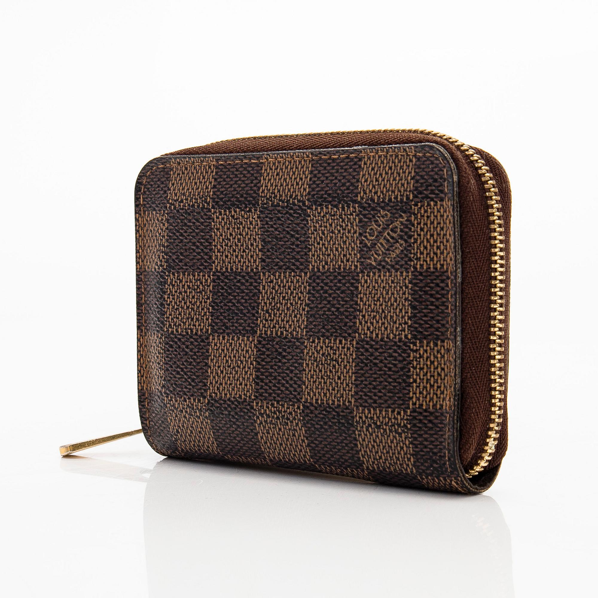 Louis Vuitton, a 'Zippy Coin Purse' wallet and an 'Inventeur' belt.