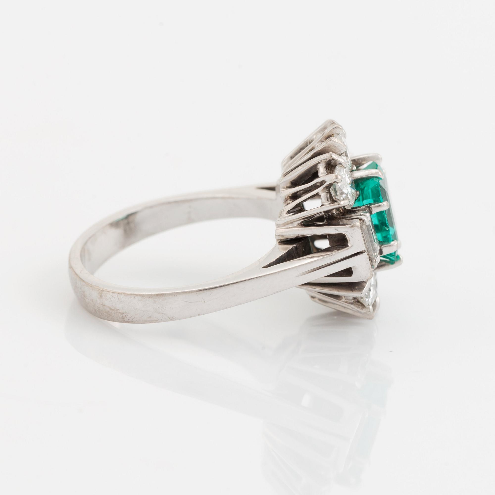 An 18K white gold ring set with a step-cut emerald.