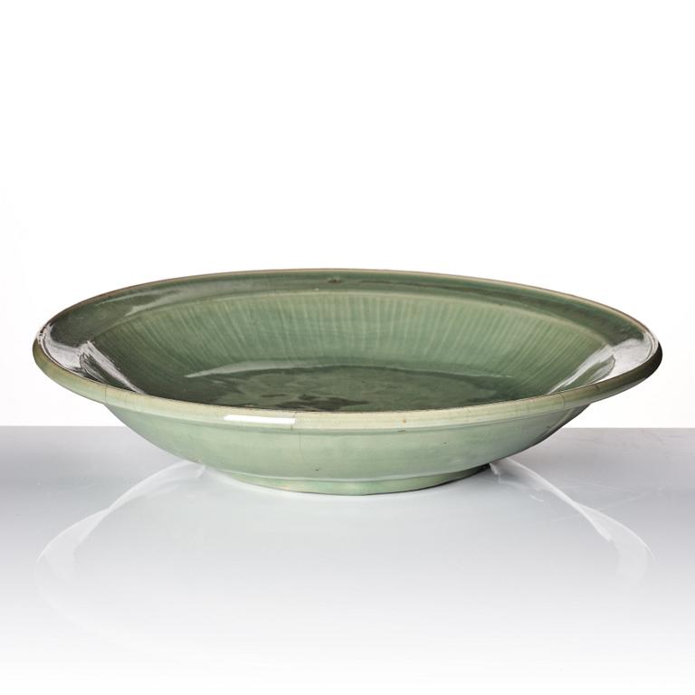 A large celadon glazed dish, Ming dynasty (1368-1644) or later.