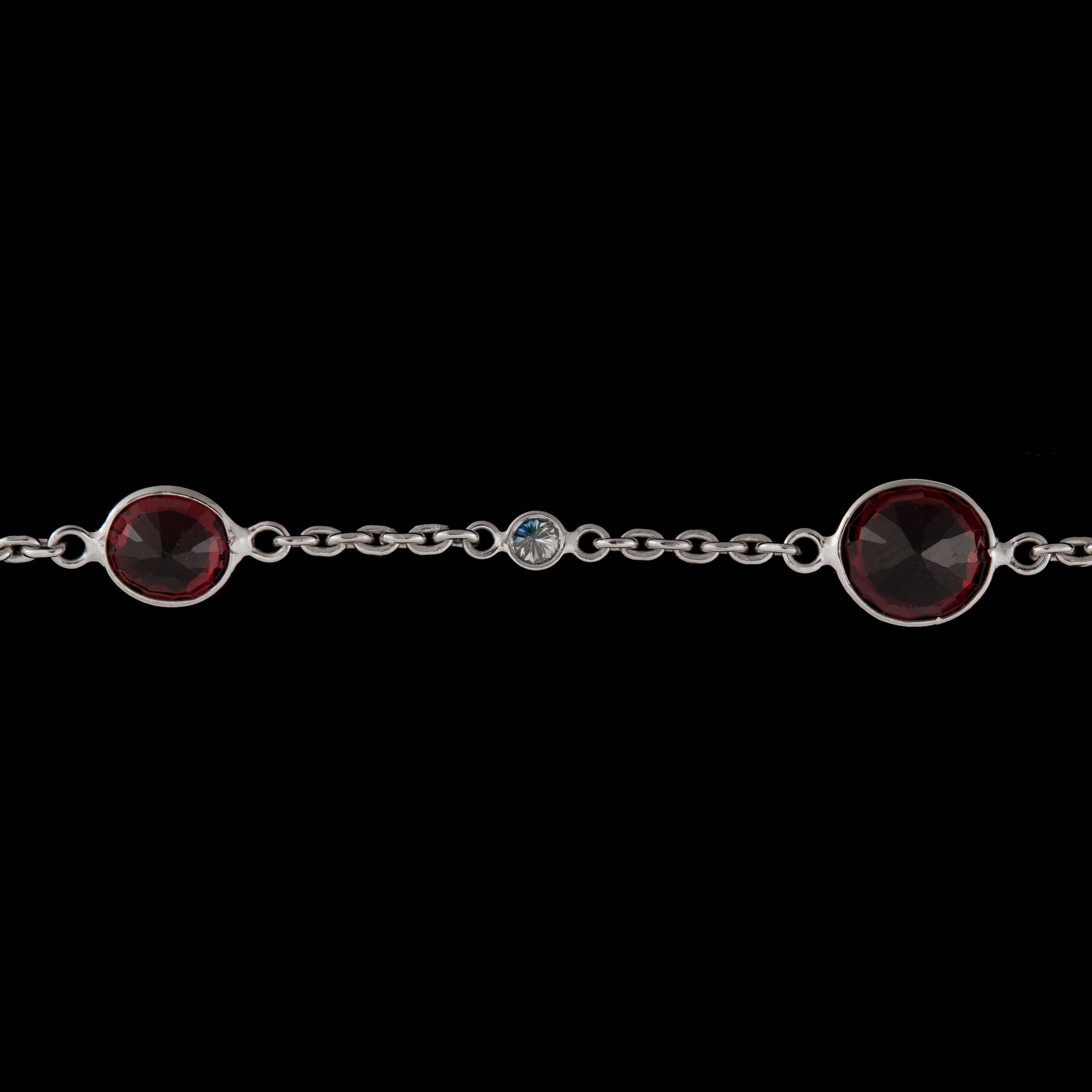 A facett cut spinel collier, 36.75 cts set with brilliant cut diamonds, tot. 0.70 ct.