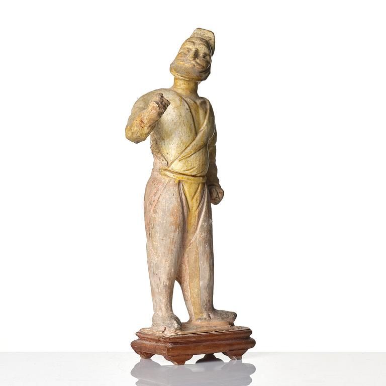 A yellow glazed potted figure of a groom, Tang dynasty (618-907).