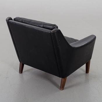 A 1960s Scandinavian black leather easy chair.