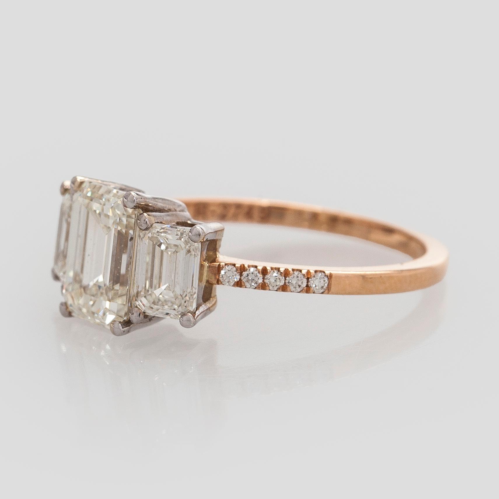 Ring, three baguette cut diamonds, small brilliant cut diamonds, 18K white gold and rose gold.