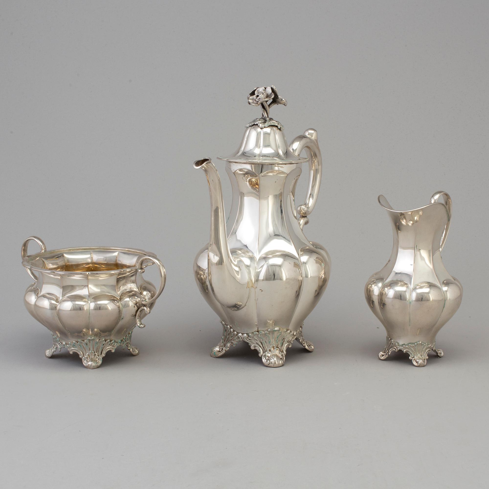 A three piece silver coffee set dated 1916-17.