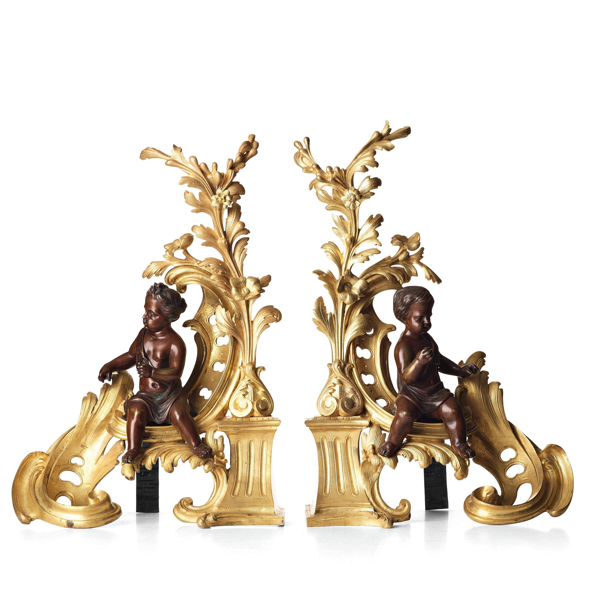 A pair of Louis XV-style 19th century fire dogs.