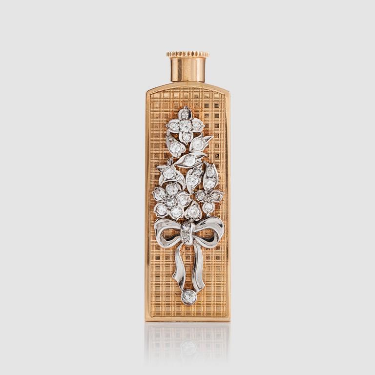 A perfume bottle set with diamonds in a floral motif.
