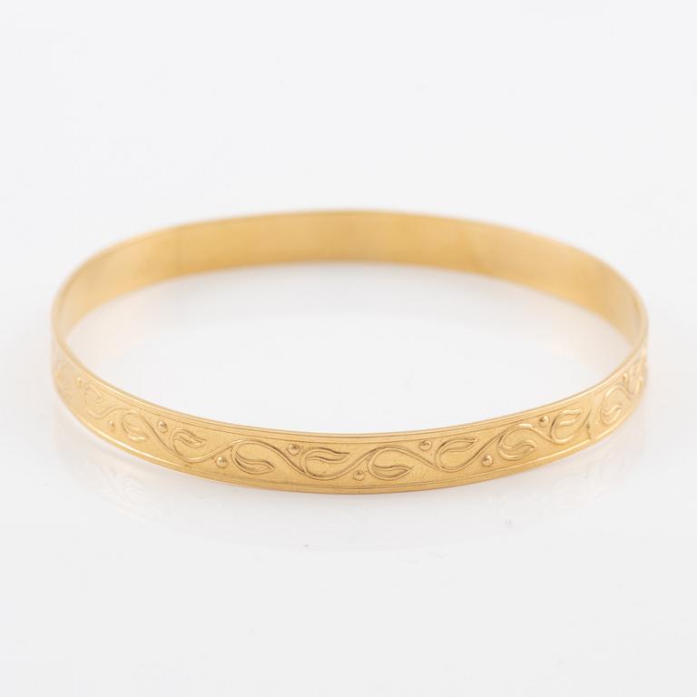 Arm ring, 18K gold with stylised decoration.