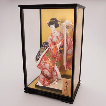 A latter half of the 20th century Japanese doll in showcase.