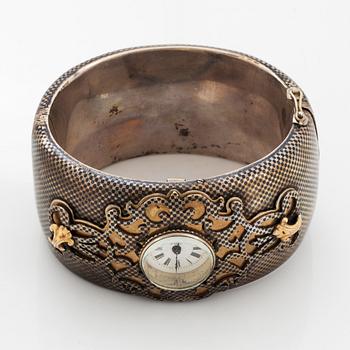 Silver bangle with watch.
