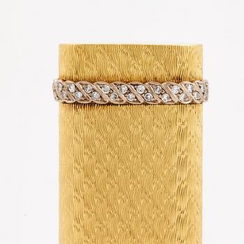 A cigarette lighter by Cartier set with single cut diamonds.