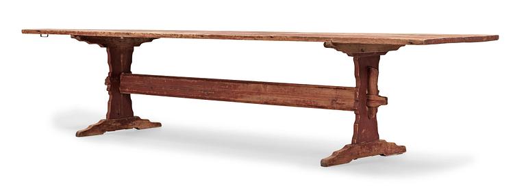 A Swedish 18/19th century red stained trestle table.