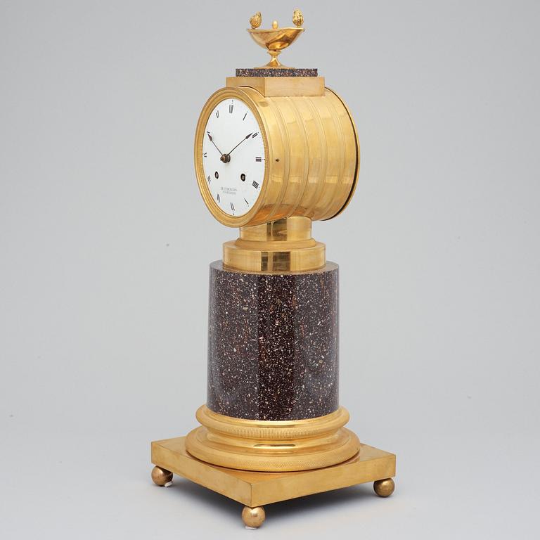 A Swedish Empire 19th century porphyry and gilt bronze mantel clock.