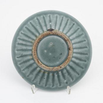 A celadon dish, for the south east asian market, double fish, Mingstyle, 20th Century. And a Chinese sealstone.