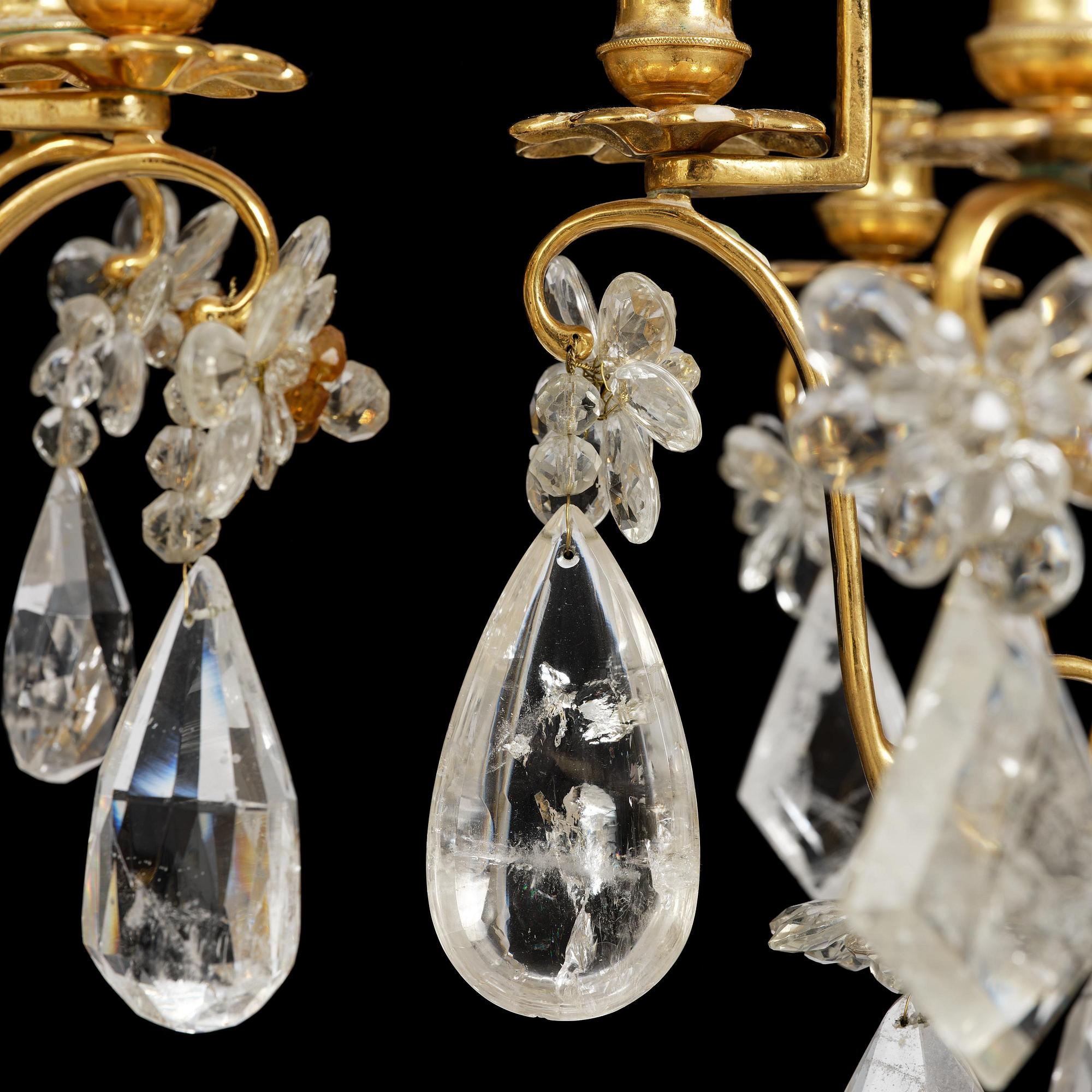 A near pair of Franch Louis-XV-style nine-branch gilt bronze and rock crystal chandeliers, later part 19th century.