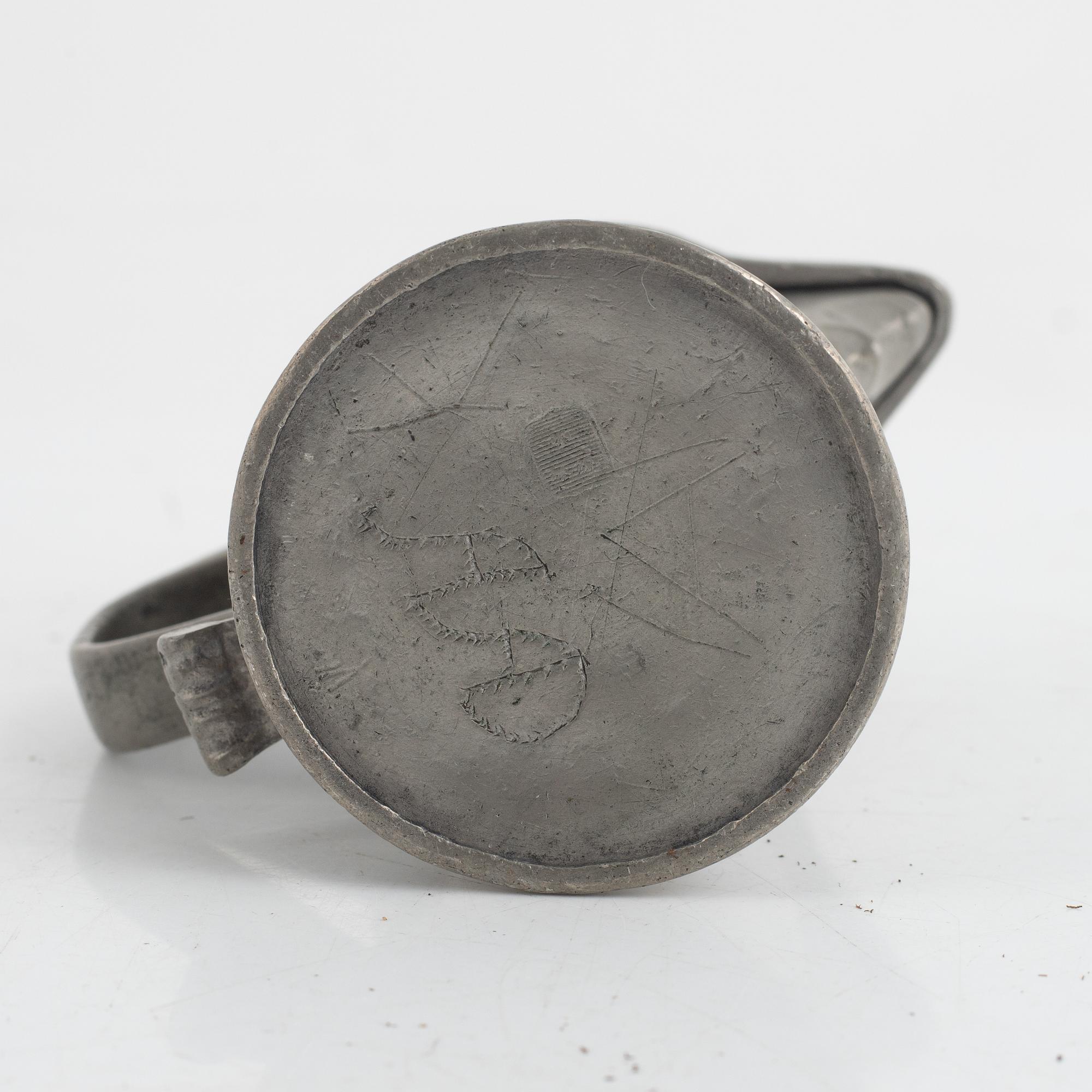A pewter measuring cup by an unidentified master, dated 1766.