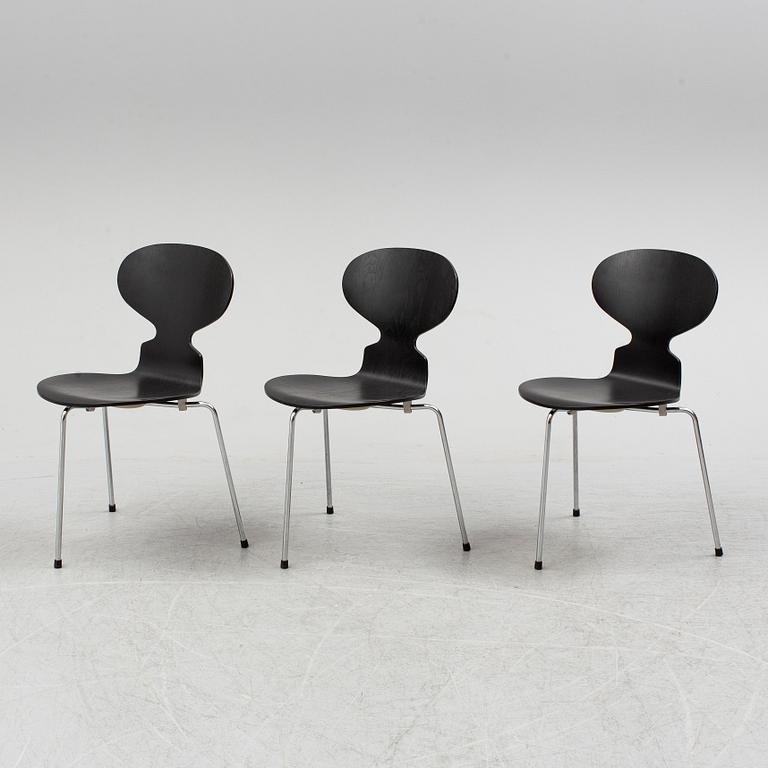 An Arne Jacobsen "Centenary Package" comprising three "Ant Chairs" and an eggshaped table, Fritz Hansen, Denmark.