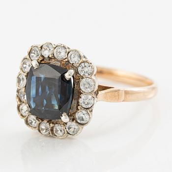 Ring in low carat gold with dark sapphire and white stones.