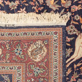 A carpet with hunting motives. 224 x 141 cm.