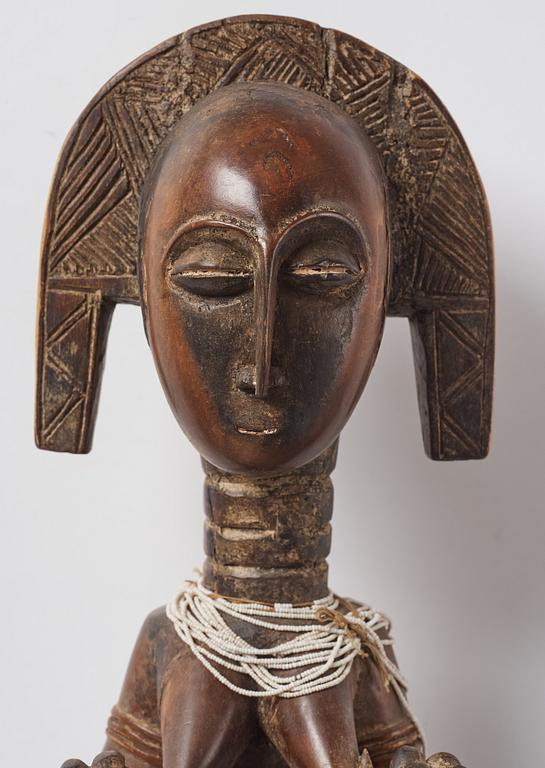 A sculptue and two masks reportedly from The Ivory coast, from the second half of the 20:th century.