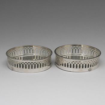 A matched pair of Swedish silver coasters, mark of Gustaf Folcker, Stockholm 1819 and 1826.