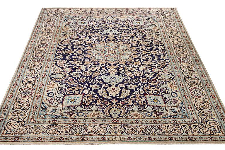 A Nain carpet, part silk, c. 338 x 244 cm.