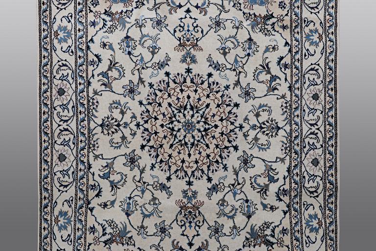 A rug, Nain, part silk, 238 x 163 cm.