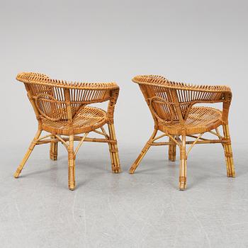 A pair of rattan chairs.