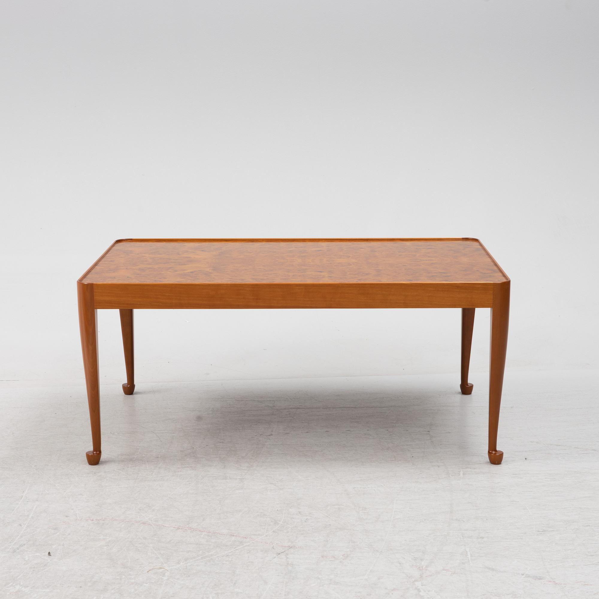A Josef Frank mahogany and elm root model 2073 coffee table, designed 1949.