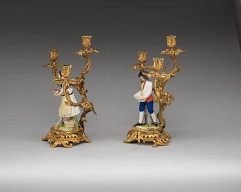 A pair of bronze candelabra with porcelain figures, French/English, second half of 19th Century.