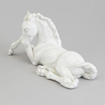A white glazed porcelain figure of a reclining foal, Meissen, 1950's.