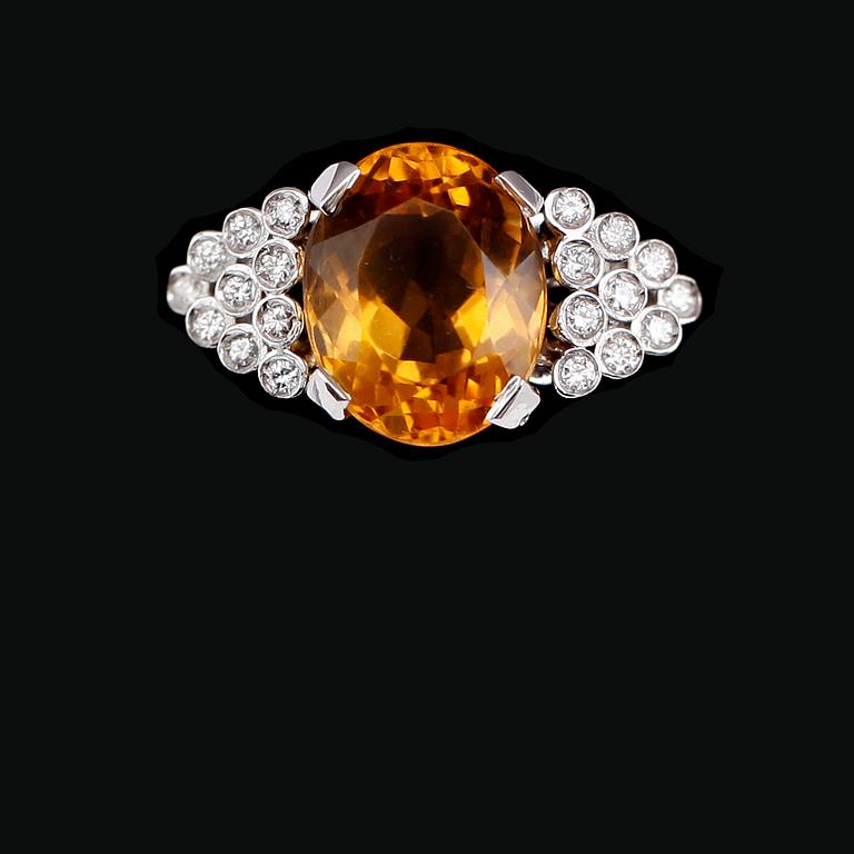 RING, 18 k vitguld, oval fasettslipad citrin ca 7.00 ct, 20 briljantslipade diamanter tot ca 0.20 ct.