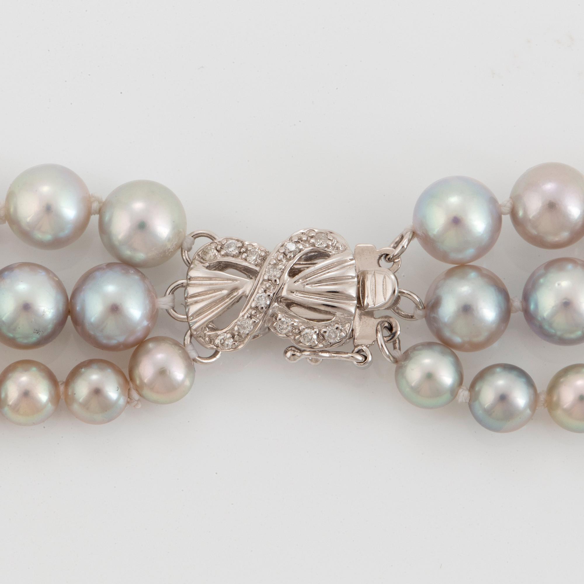 A three strand cultured pearl necklace.