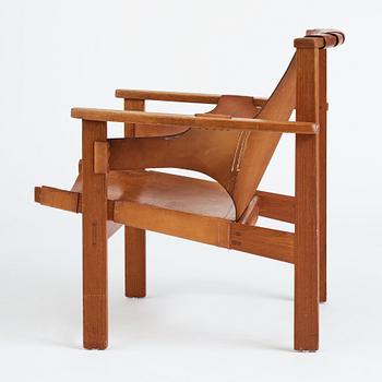 Carl-Axel Acking, a "Trienna" oak and natural leather easy chair, for Nordiska Kompaniet, Sweden 1960's.