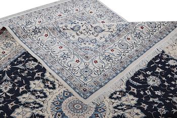 A Nain carpet, part silk, 9 laa, ca. 351 x 257 cm.