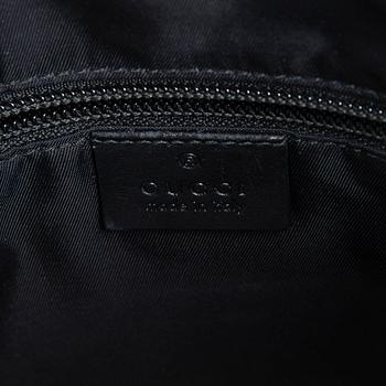 Gucci, a "Techno Canvas Web Messenger" bag.