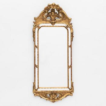 A Rococo style mirror, circa 1900.